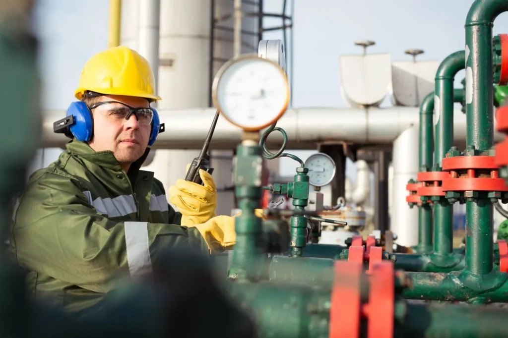 Worker checking a pressure gauge